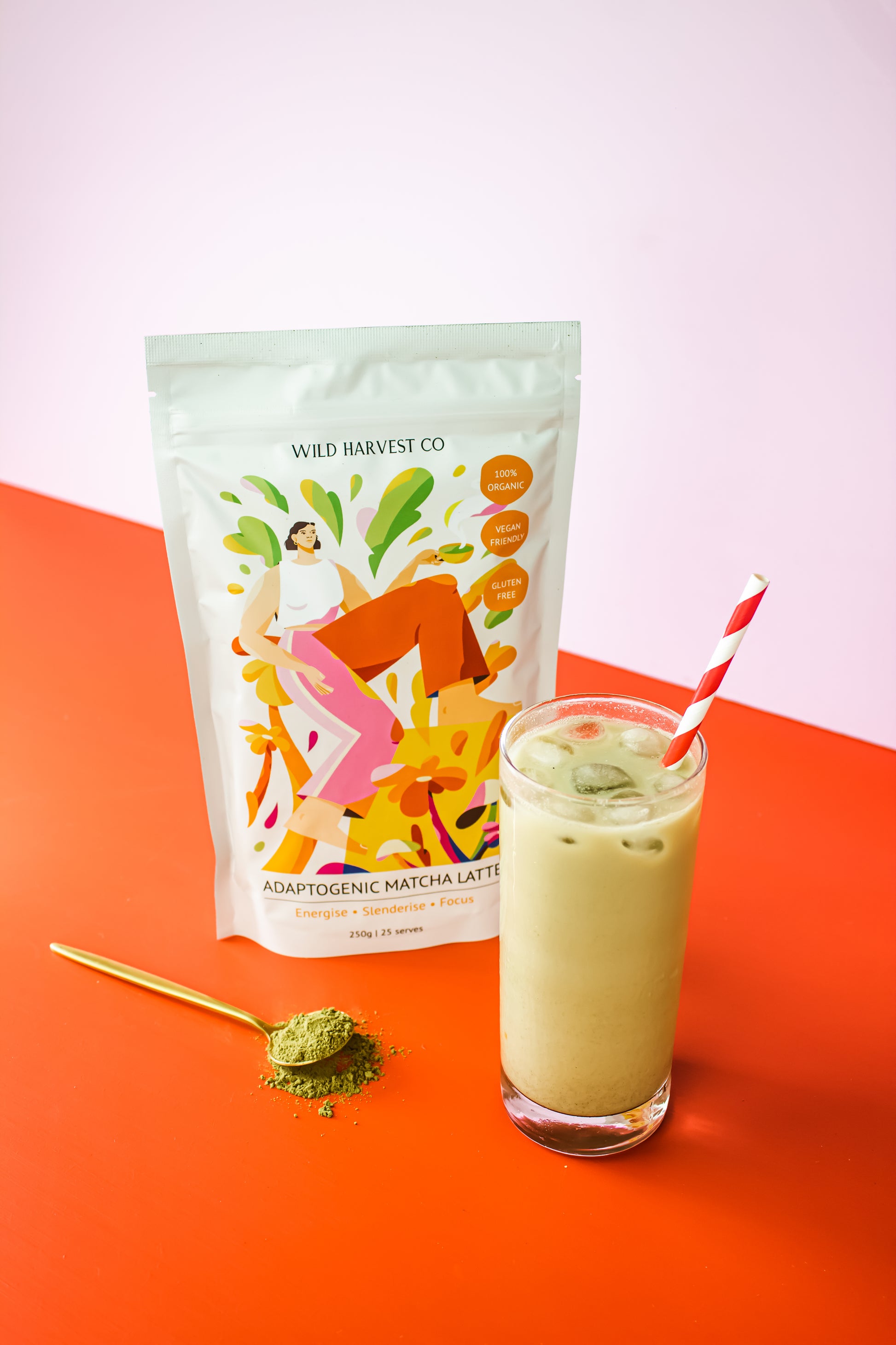 Wild Harvest Co Adaptogenic Matcha Latte Display with a mug filled with Matcha Latte, a teaspoon with Matcha latte powder and the Matcha Latte pouch